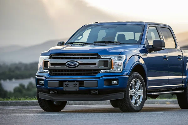 Blue Ford F150 parked on road