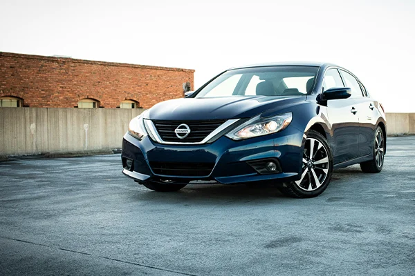 Blue Nissan sedan parked in lot