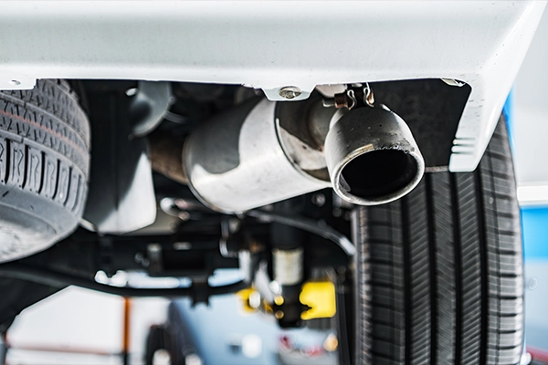 Close-up of tailpipe of white SUV
